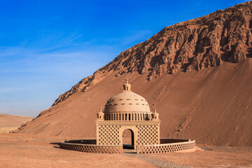 The mud building in uyghur style wirh moutain on background.
