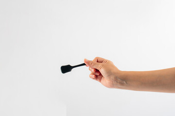 Black ice cream spoon in hand on white background