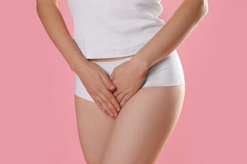 STD (sexually transmitted disease). Woman suffering from symptoms on pink background, closeup