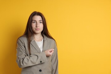 Woman making promise on orange background, space for text. Oath gesture