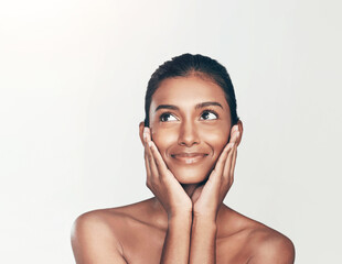 Happy, beauty and Indian woman in studio thinking with skincare, ideas and natural makeup. Smile,...