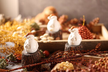 Charming Snowman Figurines in Rustic Christmas Setting with Cozy Holiday Decor and Winter Elements