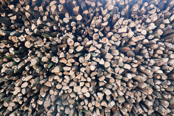 Cross-section background of a large number of firewood piles.