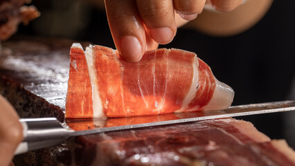 Chef cutting spanish ham Jamon iberico