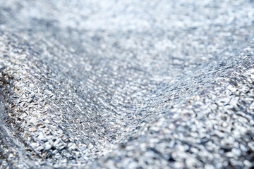 Background from shiny fabric with narrow focus