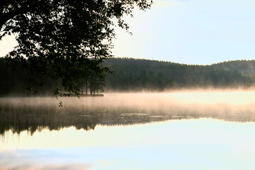 Sunrise with fog forming over a lake in Sweden, at dawn. Romantic silence