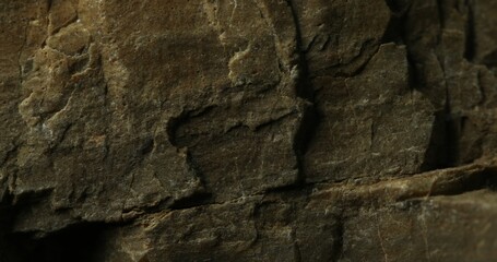 Dark Stone Surface with Natural Textures and Shadows