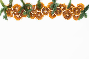 Flat lay Christmas background with dry oranges and fir tree branches on white