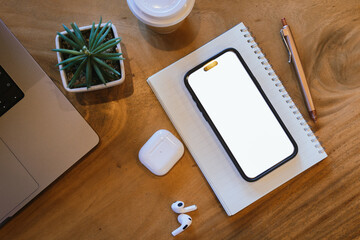 Blank laptop screen on wooden table with coffee shop interior background and blurred bokeh lights. Mockup model. Template for your text.