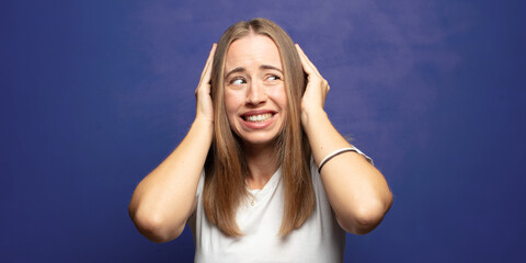 feeling stressed, worried, anxious or scared, with hands on head, panicking at mistake