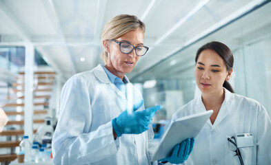 Women, scientist and discussion in lab with tablet, reading and review for experiment results at...