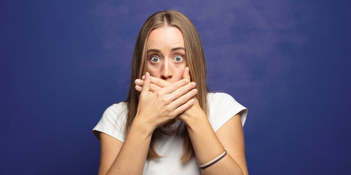covering mouth with hands with a shocked, surprised expression, keeping a secret or saying oops