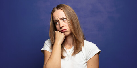 Fototapeta premium feeling sad and stressed, upset because of a bad surprise, with a negative, anxious look