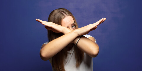 covering face with hand and putting other hand up front to stop camera, refusing photos or pictures