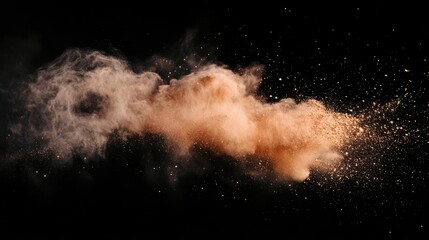 A cloud of brown powder explodes against a black background, creating a dynamic and abstract image.