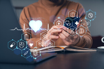 Person using mobile device with healthcare technology icons and heart symbol on dark background.