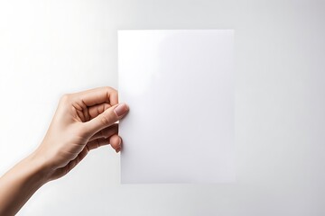Obraz premium Hands hold an empty A4 sheet of paper. A clean flyer in your hands. For your text. Isolated on a gray background.