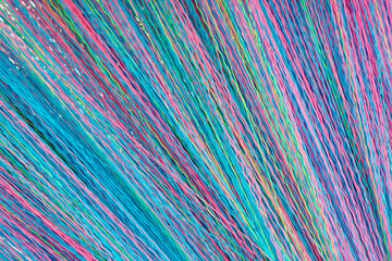 Colorful Abstract Background of Interwoven Threads Creating a Unique Textured Pattern in Striking Shades of Blue, Pink, and Green as a Visual Textile Representation