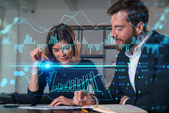 Two business professionals discussing financial charts with holographic data overlay.