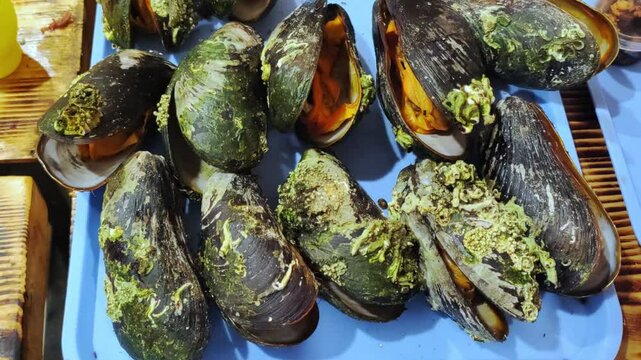 Close-up of big group fresh mussels. Street food.	