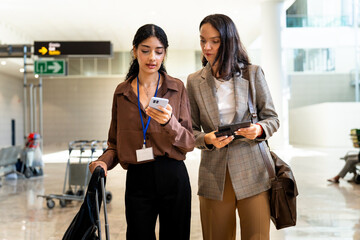 Two businesswomen walking through the airport