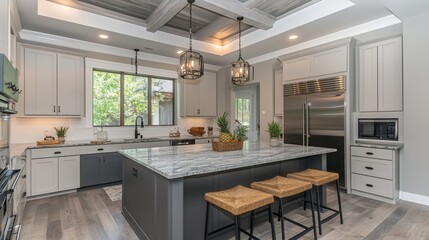 Fototapeta premium Modern kitchen with large island, gray cabinets, and wood floor.