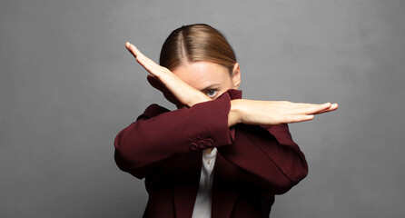 covering face with hand and putting other hand up front to stop camera, refusing photos or pictures