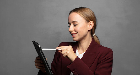 blonde businesswoman with a touch screen pad