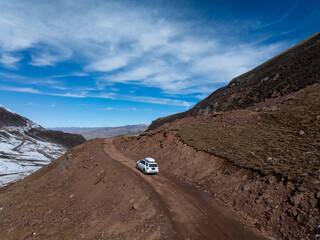 Driving off road car in high altitude mountains in tibet, China