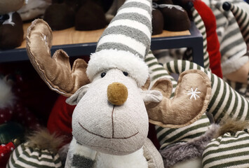 Cute soft toy Christmas deer in the store close-up.