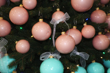 Shiny pink balls and turquoise on the Christmas tree.             