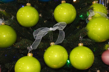 Shiny green balls on the Christmas tree.                