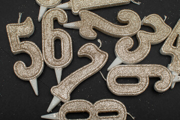 Birthday numeral candles on black background	