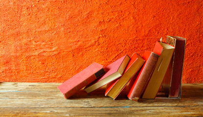 Row of red books on red background, reading, learning, education or home office concept,free copy space.