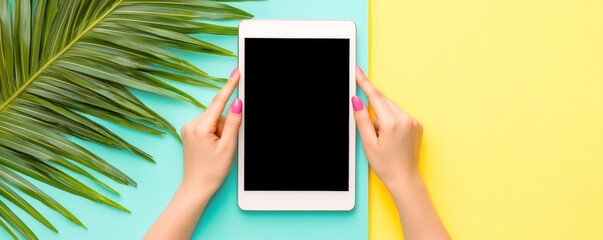mockup sample showcase for A bright, colorful image shows hands holding a blank tablet above a vibrant yellow and turquoise background with tropical leaves beside it.