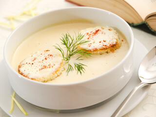 white bowl of creamy soup with toast