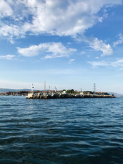 Fototapeta premium Peaceful coastal view with clear blue sky and gentle waves