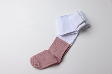 Beautiful child's tights on white background, top view