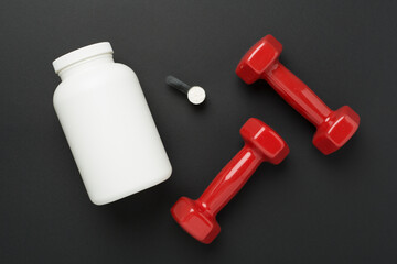 Jars with protein powder and dumbbells on color background, top view. Sports nutrition concept