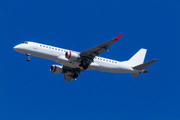 Regional jet under a deep blue sky.