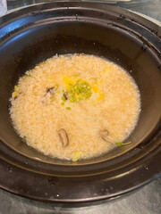 Delicious Homemade Congee with Mushrooms and Scallions in Bowl