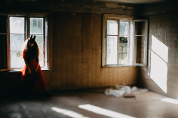 Masked Woman in Red Dress by Vintage Window..