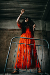 Woman in Red Dress Holding an Iron Frame