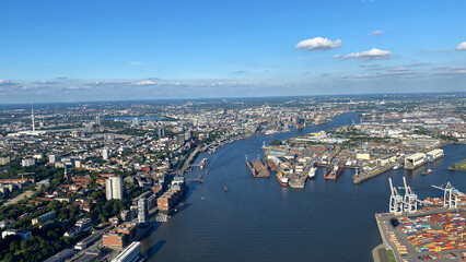 Naklejka premium Aerial View of Cityscape with River and Shipping Port