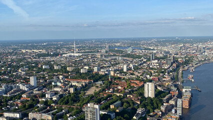 Fototapeta premium Aerial View of Sprawling Urban Cityscape Along the Riverbank