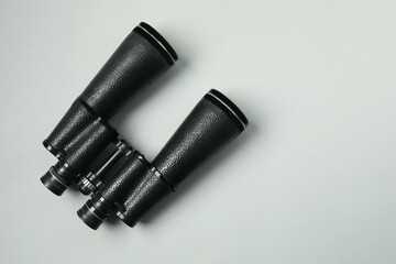 Black binoculars on gray background. Top view.