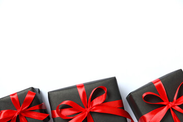 Beautiful gift box tied with golden bow on color background 