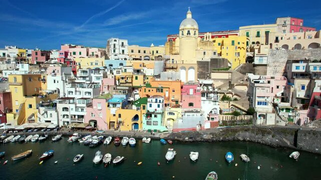 Aerial 4K View of Marina Corricella in Procida, Vibrant Colorful Houses and Fishing Boats in Old Port, Mediterranean Aesthetic, Gulf of Naples, Authentic Italian Island Summer Travel, Campania
