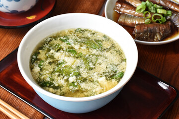 Miso soup with tofu and spinach is a savory Japanese broth made from miso paste, enriched with soft...