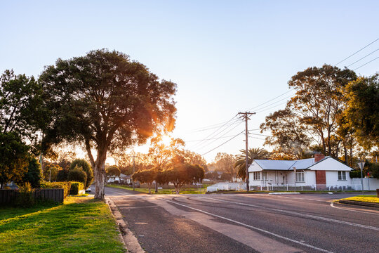 Fifty year old white cottage on the corner of roads in suburban area of country town